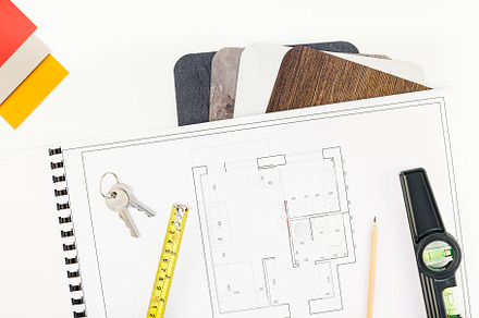 Interior designer table workplace with house plan, a Business Photo by Dvoevnore photos