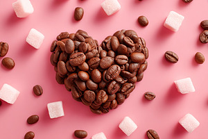 Beans arranged in a heart shape with sugar cubes on a pink background creating, a Food & Drink Photo by AlyaAnd