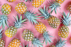 Pattern of ripe pineapples on pink background, a Food & Drink Photo by AlyaAnd