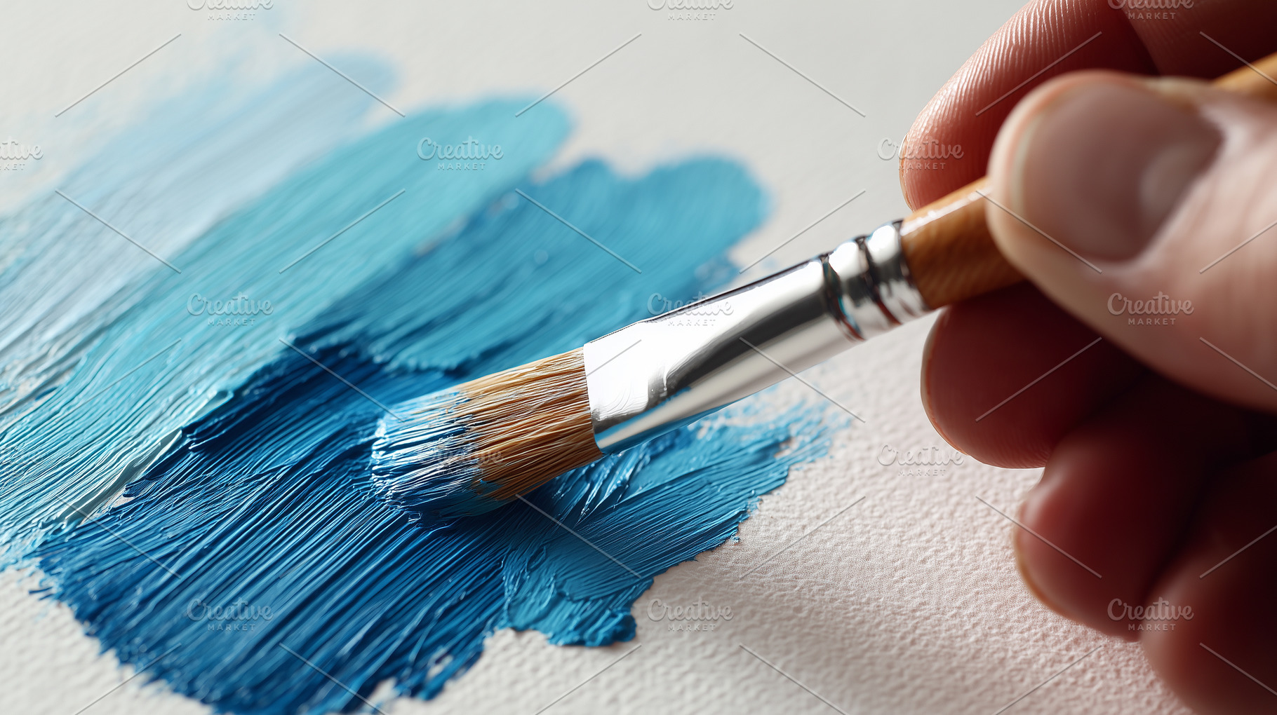 Hand uses a paintbrush to apply blue, an Arts & Entertainment Photo by MistyDay