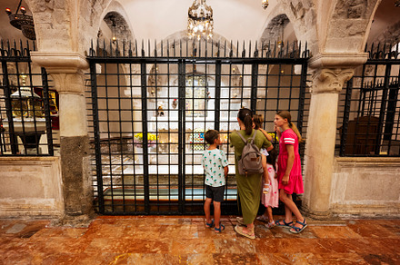 Family of tourists near relics of the Saint Nicholas in Bari, Pu, a Photo by AS photostudio