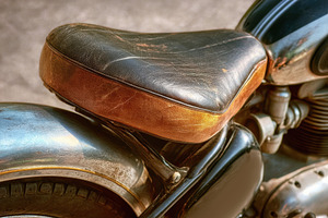 Vintage Motorcycle Seat with Worn Leather, a Transportation Photo by AlyaAnd