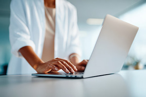 Woman working on laptop in modern office, a Business Photo by AlyaAnd