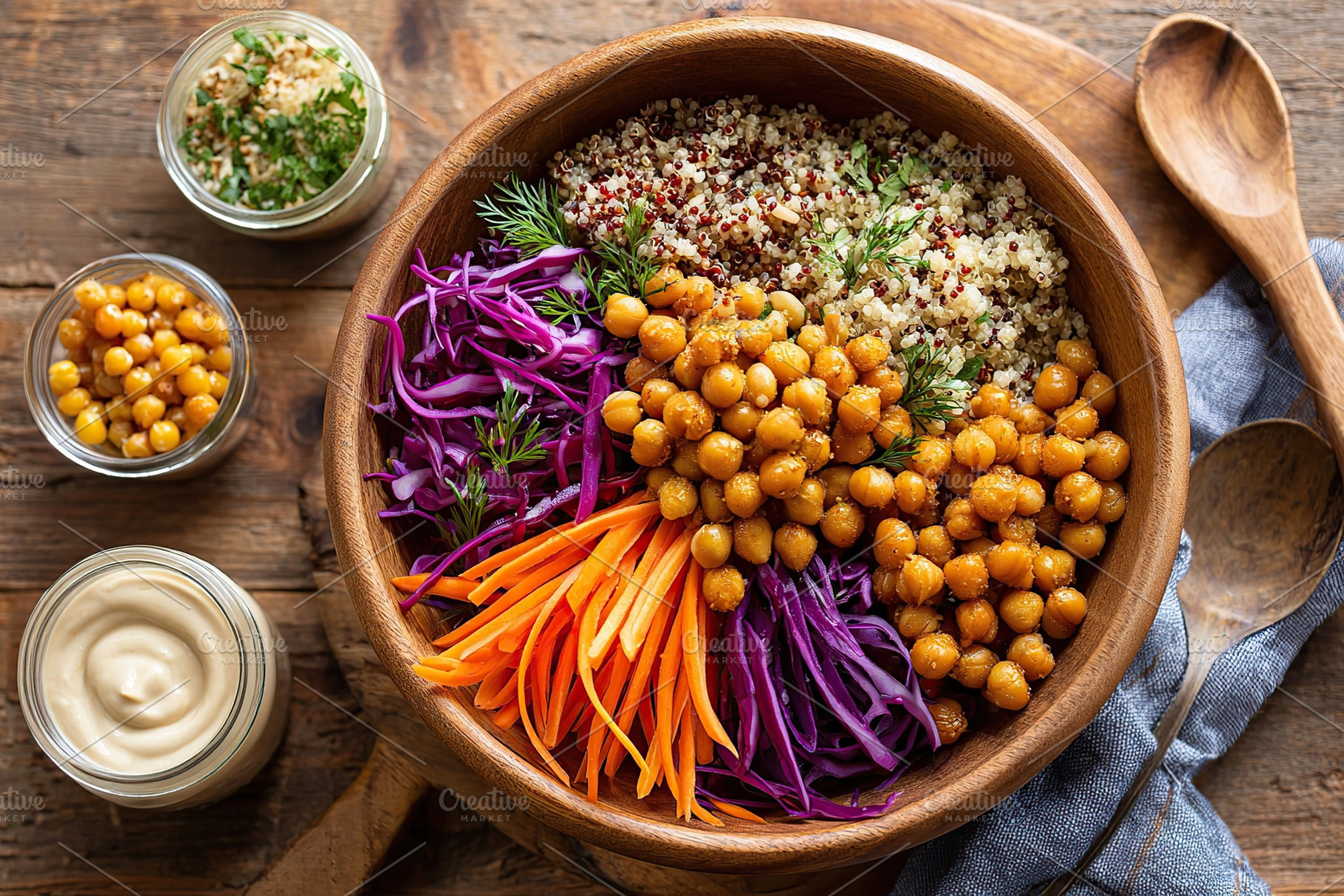 Colorful vegan Buddha bowl with quinoa, chickpeas, and fresh vegetables on wood, a Food & Drink Photo by AlyaAnd