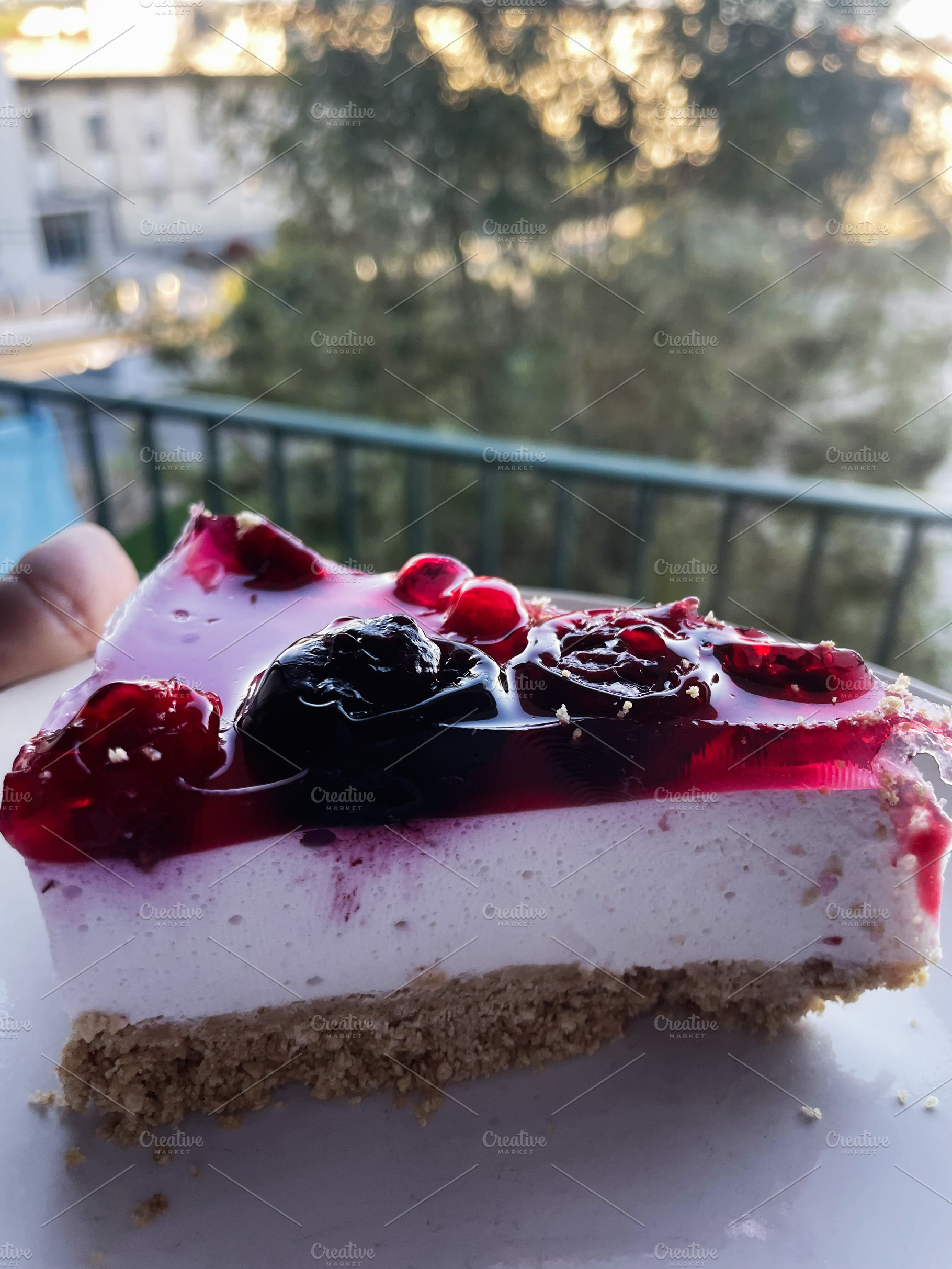 Delicious berry cheesecake slice captured during a calm evening outdoors, a Photo by AS photostudio