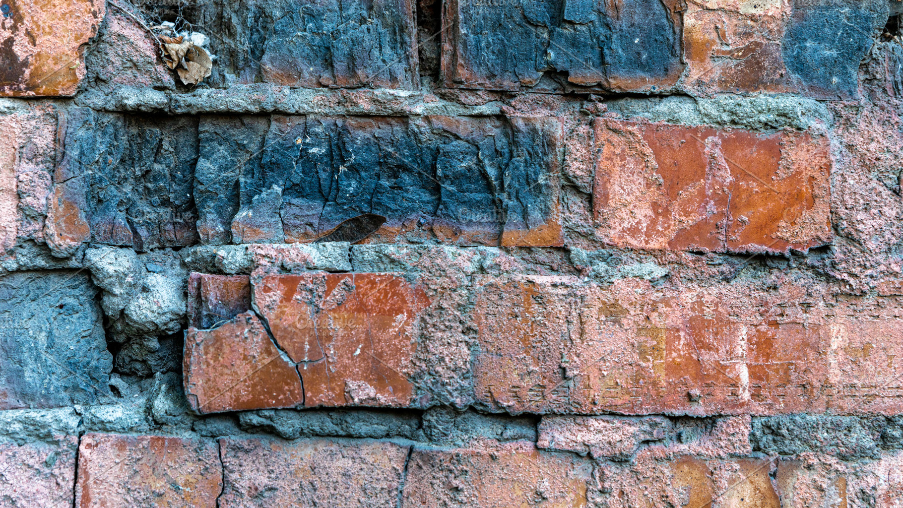 Close-up of an old red brick wall with chipped edges, dark stain, a Background Photo by Ales Munt