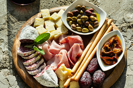 Italian snack and antipasti on a tray and red wine: prosciutto,, a Food & Drink Photo by IriGri
