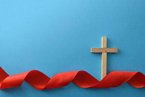 Wooden Cross with Red Ribbon on Blue Background, a Holiday Photo by Davizro's Market