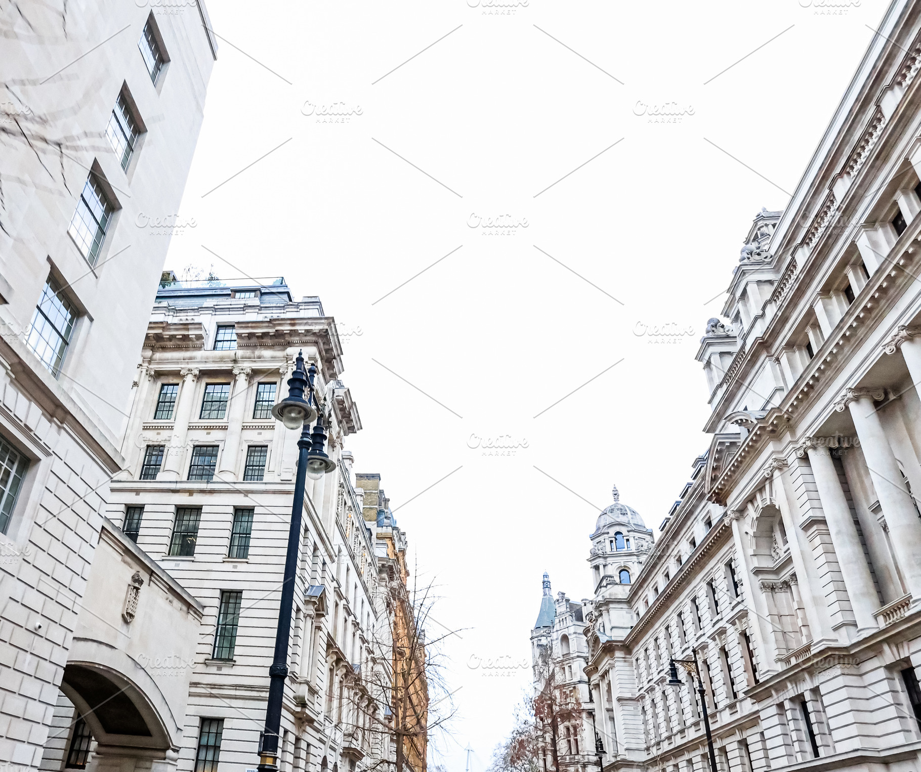 London street architecture with ornate classical buildings and a lamppost under, a Photo by Studio ANNA