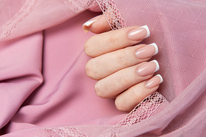 Woman showing french manicure on pink background with lace, a Beauty & Fashion Photo by Olena Rudo
