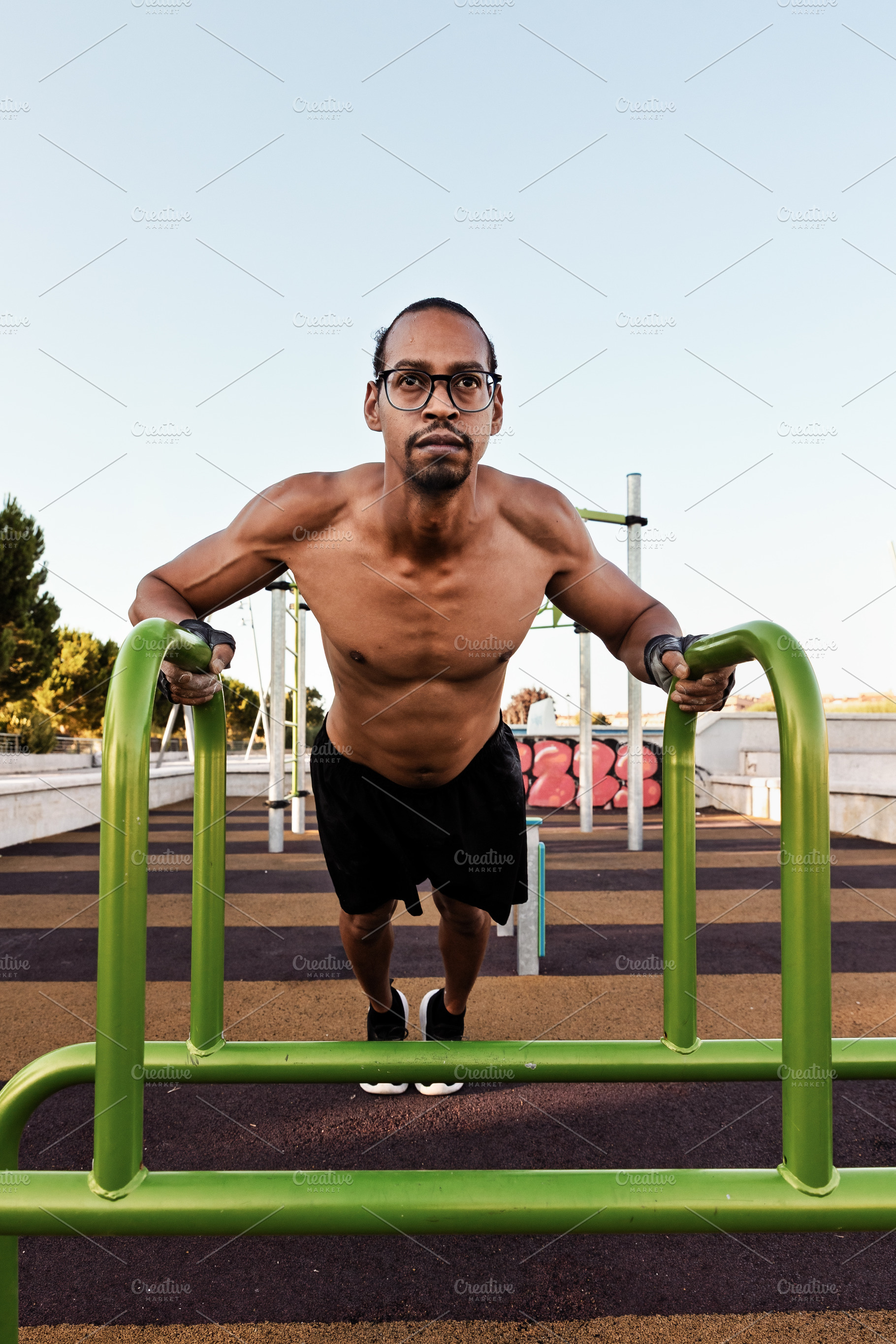 Man doing incline push-ups on parall, a Sports & Recreation Photo by Perpis
