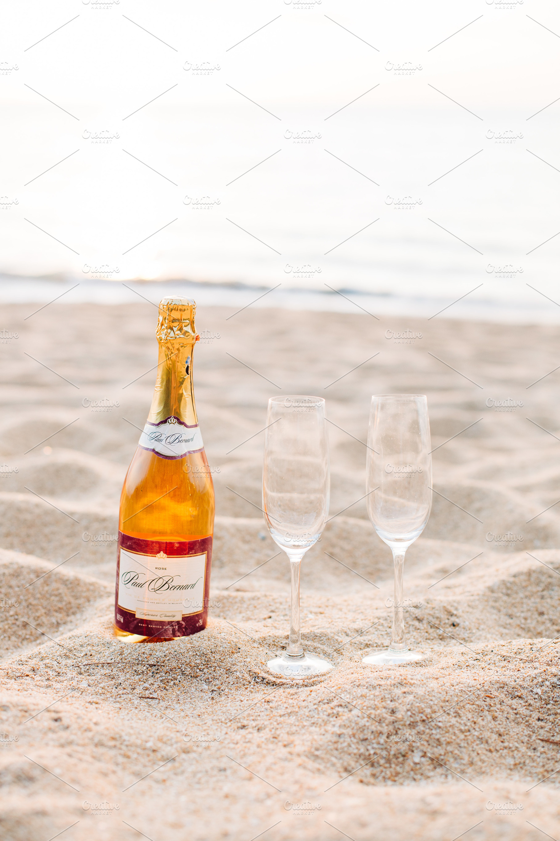 Two drinking glasses and bottles, a Food & Drink Photo by Beach Babe Stock