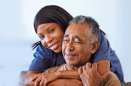 Nurse hug, senior man and healthcare support in consultation in home, help with health from doctor and medical communication in retirement in house. Portrait of African caregiver working at clinic, a Photo by Peopleimages.com