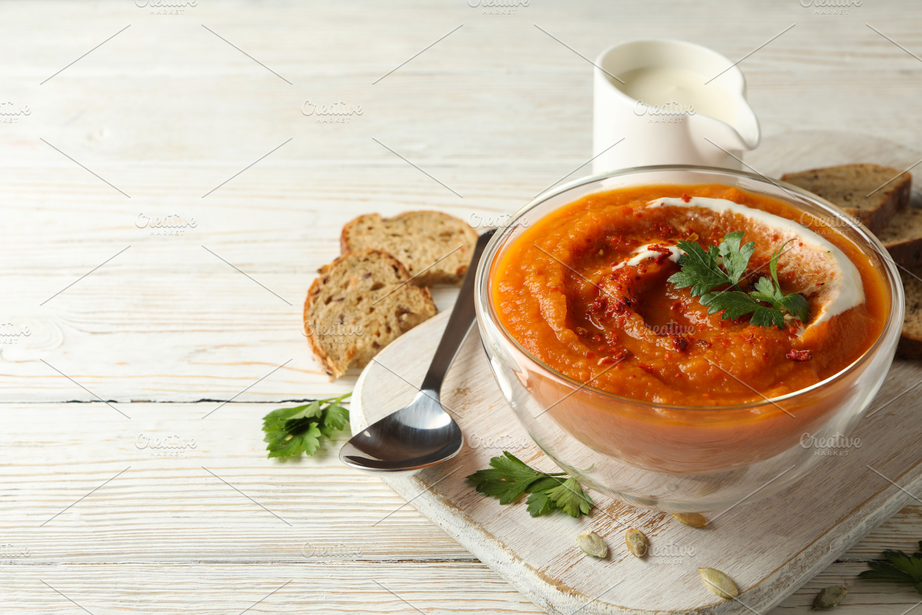 Composition with bowl of pumpkin soup on white wooden background, a Food & Drink Photo by AtlasStudio PRO