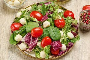 Plate of fresh salad with mixed greens, cherry tomatoes and mozz, a Food & Drink Photo by ndanko