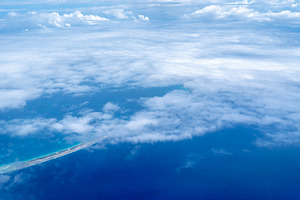 Aerial view of the Tuamotus atoll in French Polynesia with cloud, a Nature Photo by GoodGoods