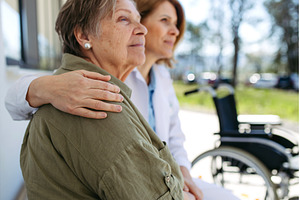 Doctor and elderly patient sitting, a Health & Medical Photo by HalfPoint