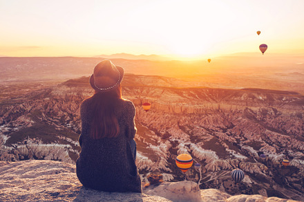 Girl admires flying balloons