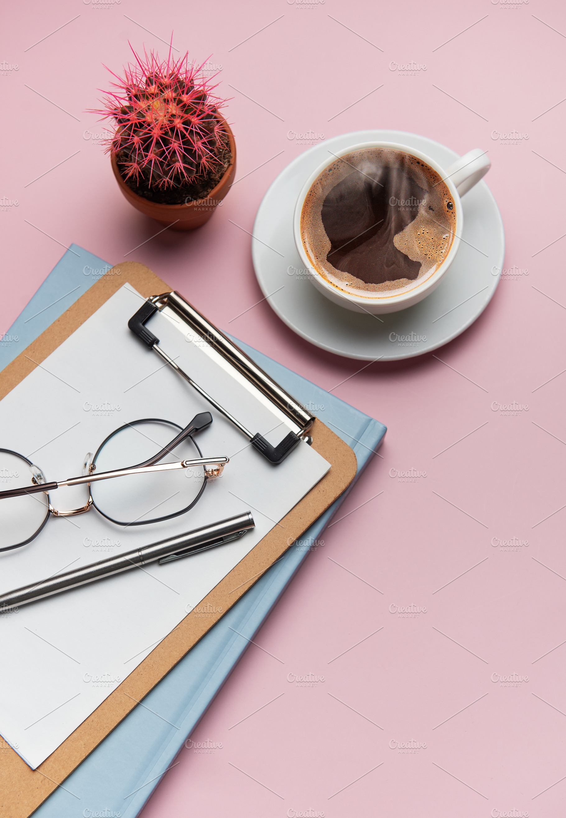 Coffee break accessories arranging on pink table with cactus pla, a Business Photo by Olena Rudo