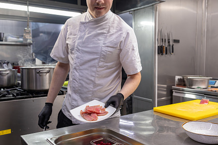 Chef preparing tuna salad, a Photo by Grafvision photography