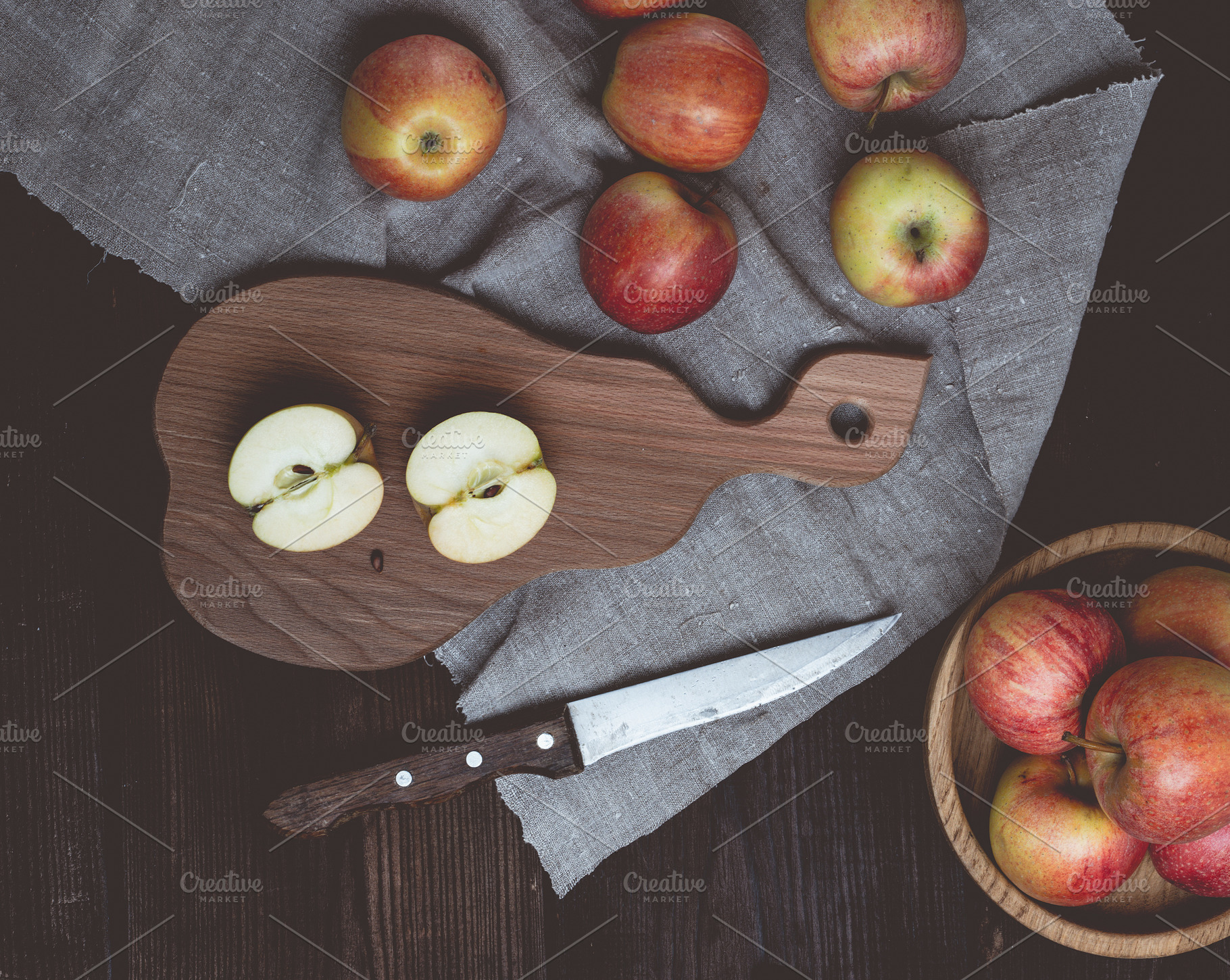 Ripe red apples on a wooden board, top view, a Food & Drink Photo by ndanko