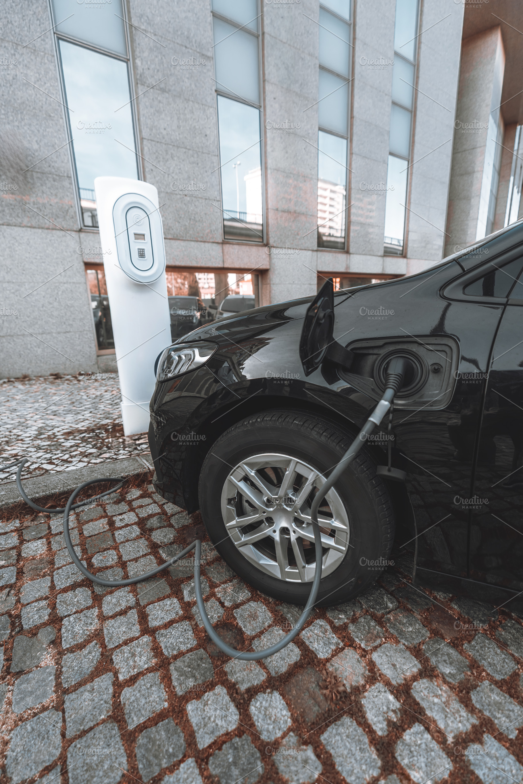 Electric car at EV charging station, a Transportation Photo by SkyNext