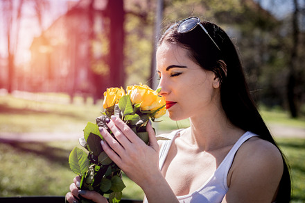 Woman smelling the flowers featuring people, beautiful, and young