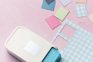 Paper punch creating decorative elements from colorful paper pie, an Arts & Entertainment Photo by Olena Rudo