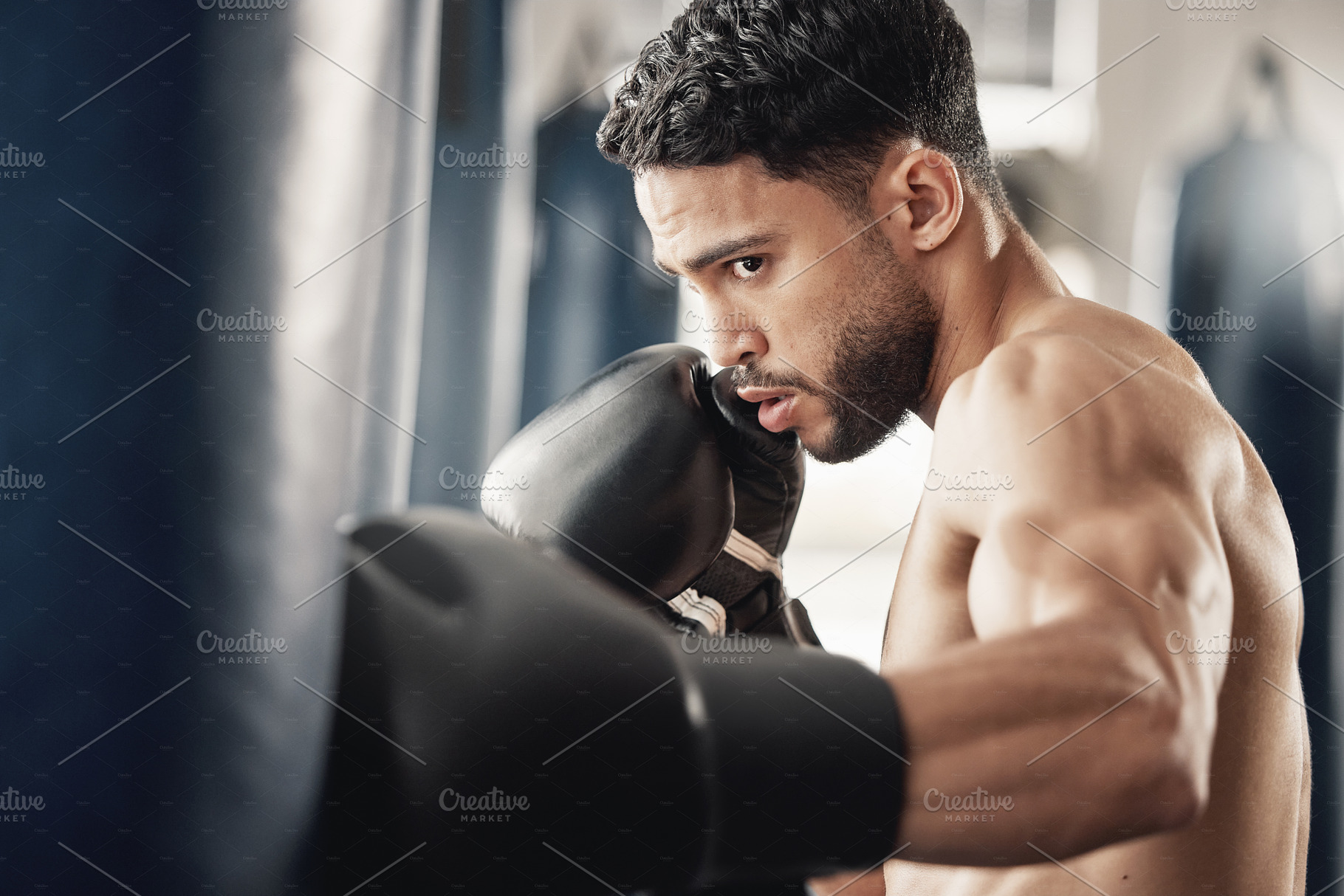 Training, fitness and workout man boxing punching bag for health, wellness and cardio exercise in gym. Sport, trainer or warrior athlete with strong, healthy and motivation for event or sports fight., a Photo by Peopleimages.com