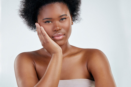 Black woman, portrait and relax in skincare with afro for natural beauty against a white studio background. African female person or model satisfaction for perfect skin, hygiene and facial treatment, a Photo by Peopleimages.com