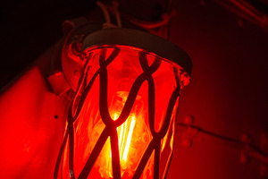 Red alarm light inside an old military submarine with protective, a Background Photo by GoodGoods