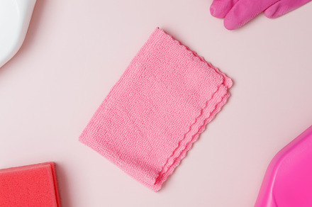 Household cleaning and hygiene concept. Pink cleaning supplies including rubber, a Photo by matucha