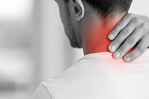 Man suffering from neck pain holding, a Health & Medical Photo by MistyDay