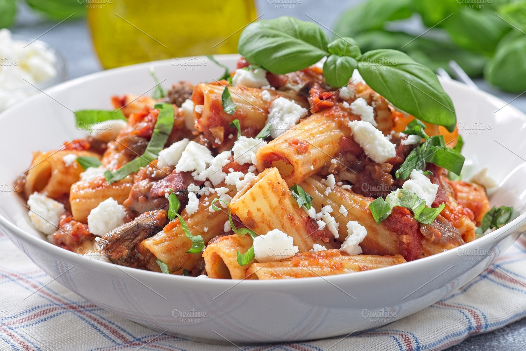 Rigatoni alla Norma pasta with eggplant and tomato, basil and ricotta salata, h, a Food & Drink Photo by iuliia_n