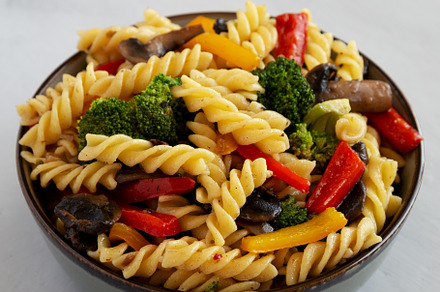 Homemade Garlic Veggie Rotini Pasta in a Bowl on a gray backgrou, a Food & Drink Photo by LiudmylaChuhunova