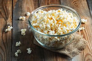 Popcorn on wood color background.Food and snack concepts ideas.Minimal style to, a Food & Drink Photo by Budarinphoto