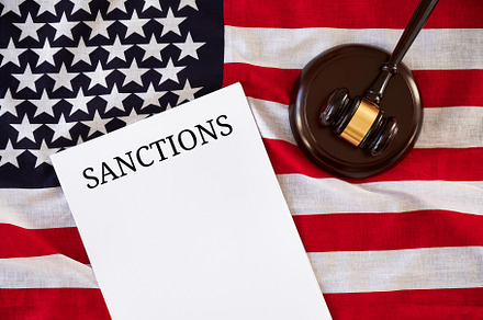 Sanctions list and judge's gavel on background of USA flag., a Business Photo by photoguns
