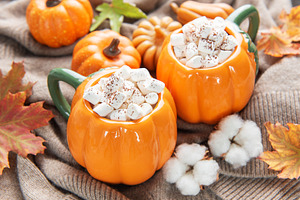 Warm hot chocolate in pumpkin mugs celebrating autumn, a Food & Drink Photo by Olena Rudo