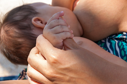 Mother feeds the baby with the breast featuring baby, mother, and child, a Person Photo by Photostock