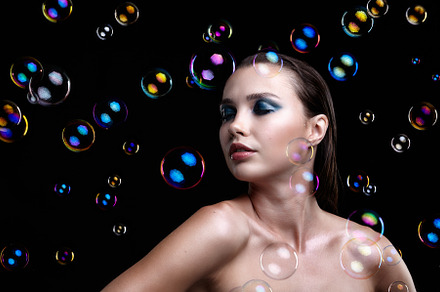 Beautiful young brunette woman with soap bubbles on black backgr, a Beauty & Fashion Photo by Zastavkin