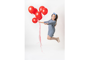Girl in jump holding large bunch of, a Person Photo by Alexander-Piragis