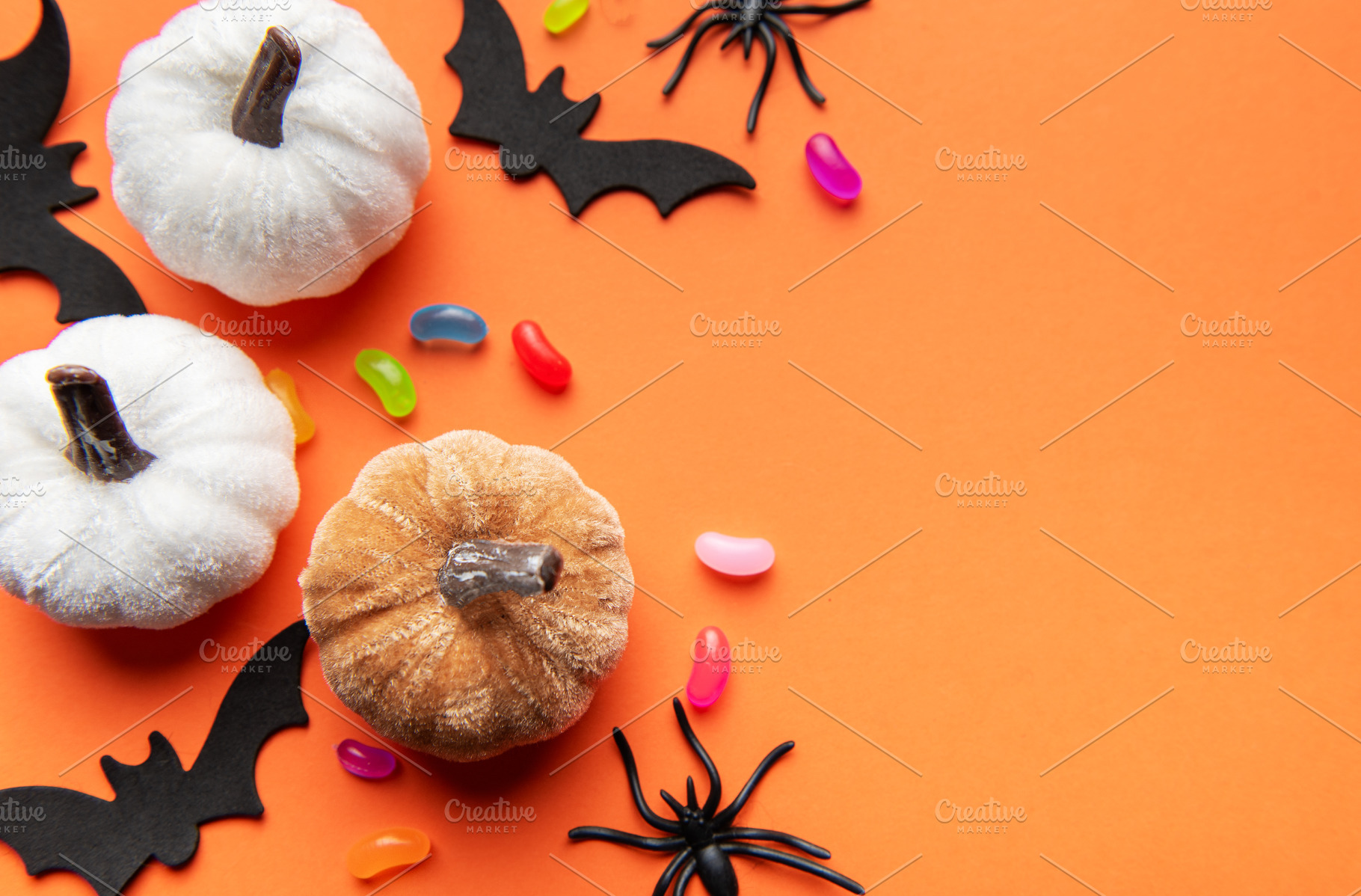 Halloween pumpkins bats spiders and candy corn on orange backgro, a Holiday Photo by Olena Rudo