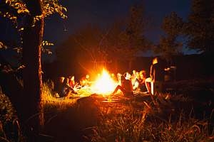 People sitting around the bonfire