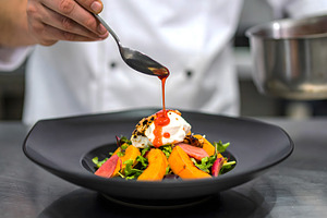 Chef Garnishing Salad with Poached, a Food & Drink Photo by Stock Shape