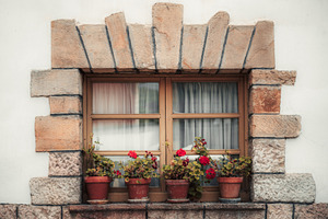 Stone window with red flowers, an Architecture Photo by SkyNext