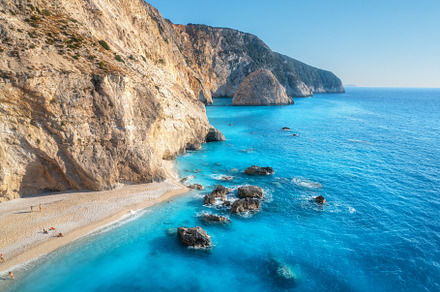Aerial view of blue sea, rocks, sandy beach at sunny day, a Nature Photo by den-belitsky