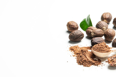 Concept of spices and condiments, nutmegs, space for text, a Food & Drink Photo by AtlasStudio