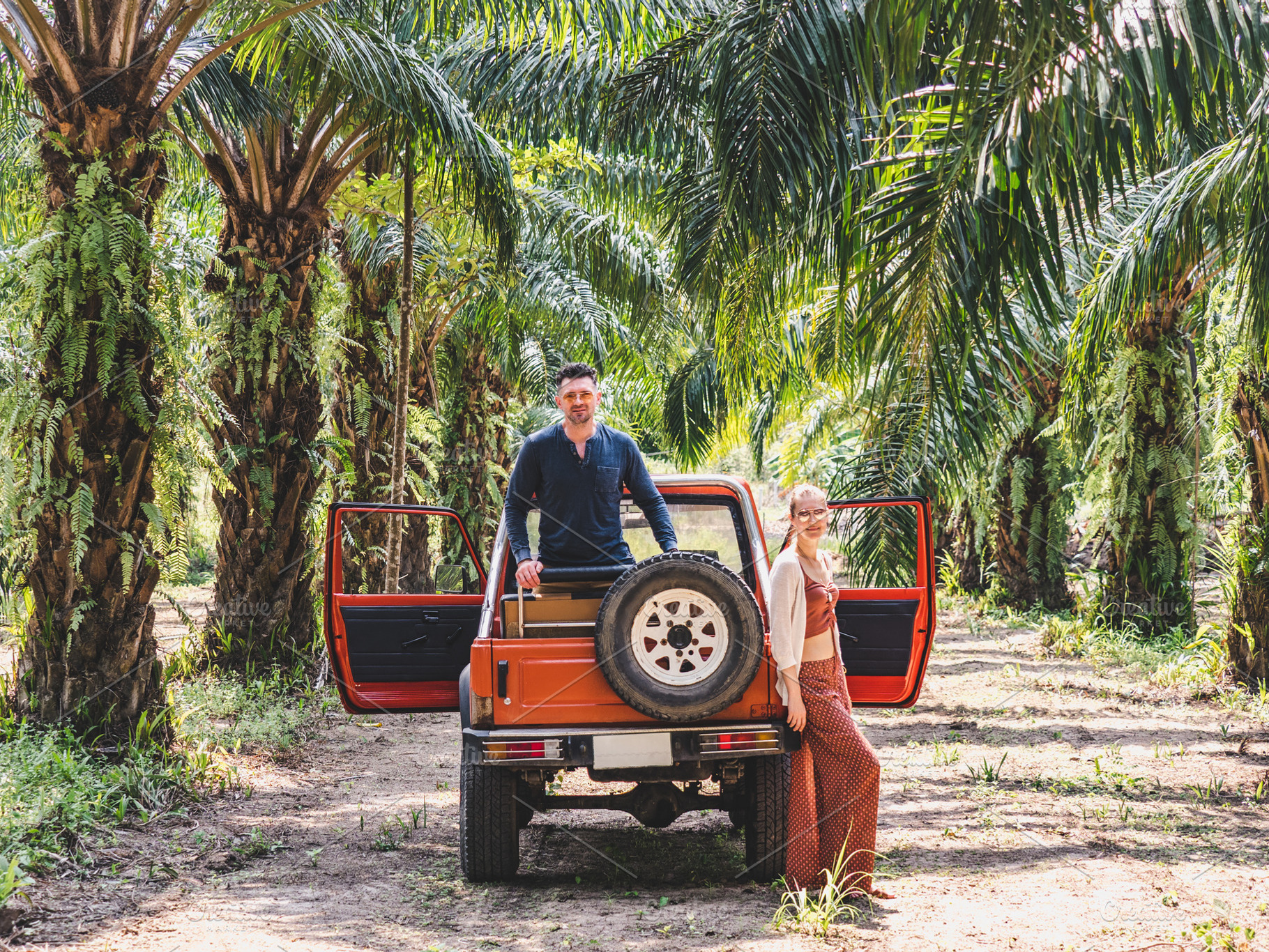 Attractive man, cute woman and a red SUV, an Animal Photo by Svetlana Barchan
