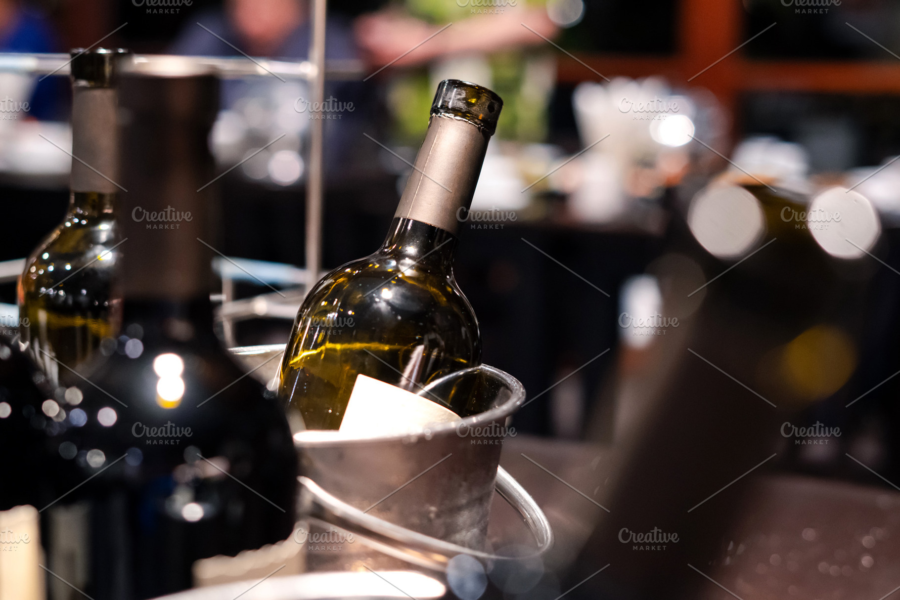 close-up of red wine bottle in ice bucket on romantic table, bac, a Health & Medical Photo by Casanowe-studio