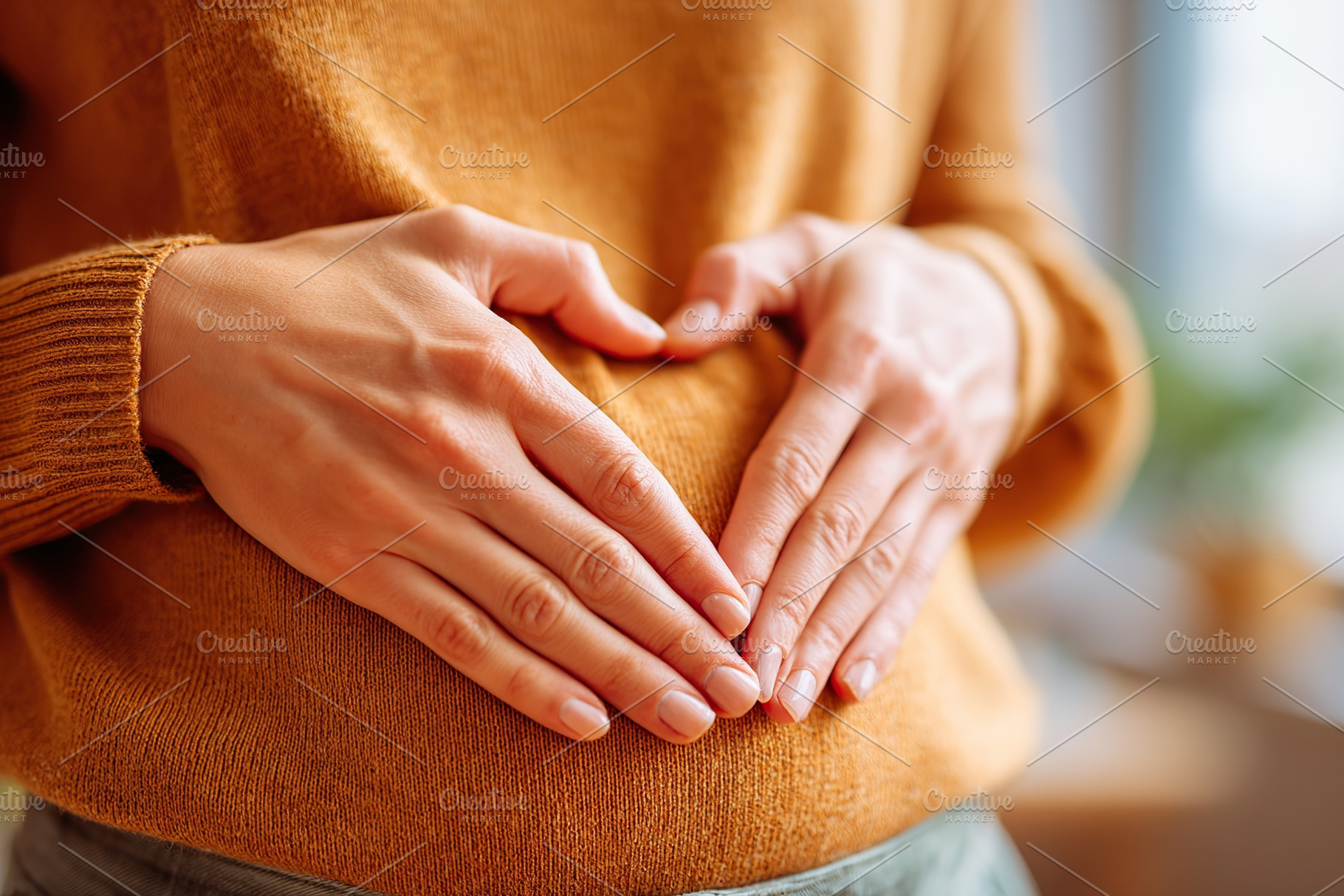 Hands form a heart shape on pregnant woman's belly in cozy indoor setting, a Person Photo by AlyaAnd